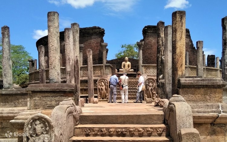 Travellers exploring ancient temple ruins in Sri Lanka at sunrise